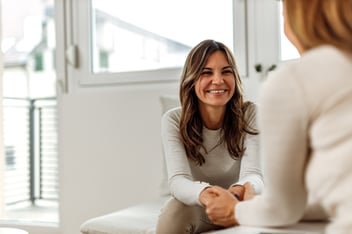 Woman talks to a caring mental health professional 