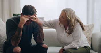 Man struggling with mental health is comforted and supported