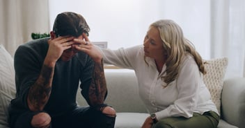 Man struggling with mental health is comforted and supported
