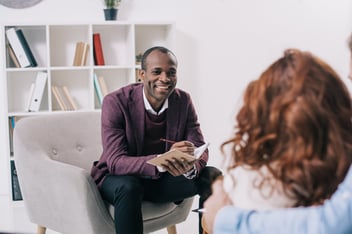 Caring mental health professional talking to person who reached out for help