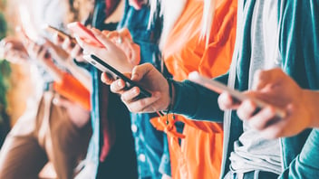 Group of people all on their phones while together