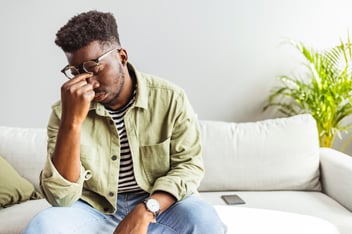 Man looking worn out and overwhelmed by stress and/or anxiety